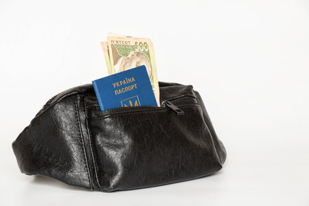 Ukrainian passport and 500 hryvnia bills in a waist bag on a white background, documentsの写真素材