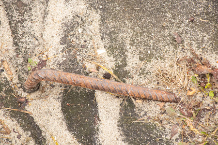 Rusty metal reinforcement sticking out of the ground at a construction siteの写真素材