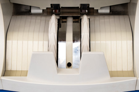 The banknote gripper unit inside a banknote counting machine, a close-up of the mechanism for sorting and counting moneyの写真素材