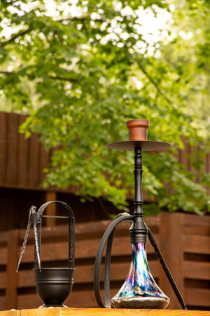 Hookah on a table outside against a wooden fence in Ukraine, outdoor recreation, hookah outside in summerの写真素材