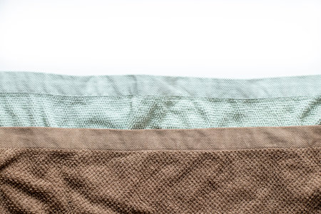 Two beige and mint terry towels on a white background, bathroom and home textiles, fabric textureの写真素材