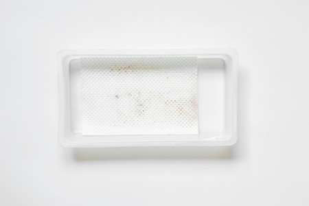 Empty plastic packaging with absorbent napkin after removing salmon on white backgroundの写真素材