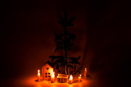 New Year tree, candles and wooden calendar with the date December 31 in the dark, New Year decorの写真素材