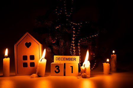 New Year tree, candles and wooden calendar with the date December 31 in the dark, New Year decorの写真素材