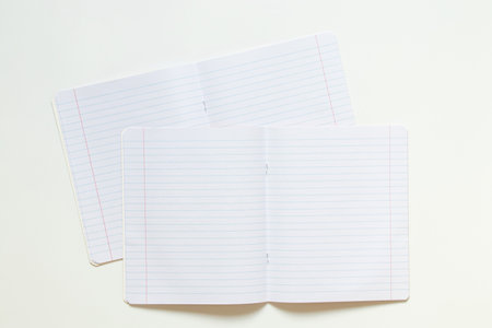 Two lined notebooks fastened with staples on a white background, educational background for school and educationの写真素材