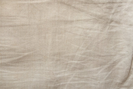 Natural beige linen fabric texture close-up, background for design and creativityの写真素材