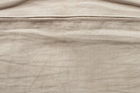 Natural beige linen fabric texture close-up and horizontal zipper, background for design and creativityの写真素材