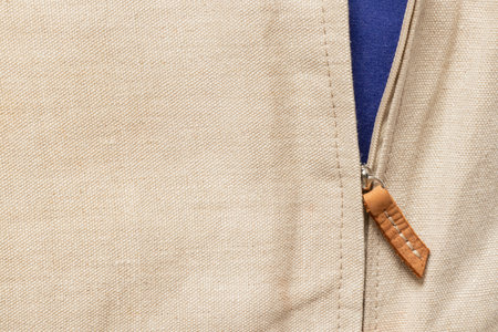 Natural beige linen fabric with open zipper and blue fabric at the bottom, fabric as backgroundの写真素材
