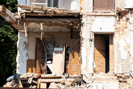 Destroyed residential building after missile strike in Ukraine, collapsed wall and damaged floors,...