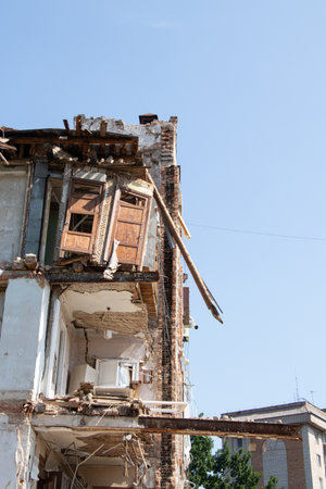 Destroyed residential building after missile strike in Ukraine, collapsed wall and damaged floors,...