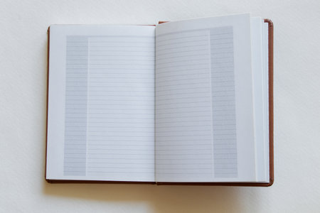 Open notebook with blank page on white background, top view, template for text, plans or notes