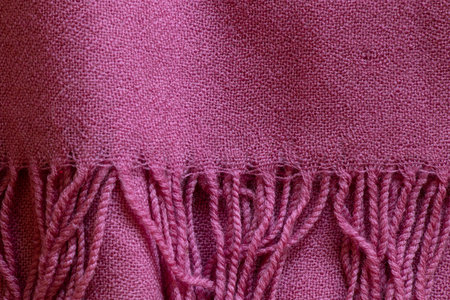 Pink knitted scarf close-up with thick ropes, fabric texture for background and designの写真素材