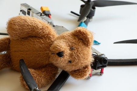 Teddy bear and combat drone on white backgroundの写真素材