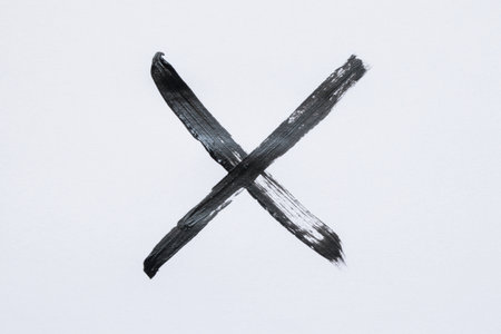 Black watercolor X on white background, sign of error or prohibitionの写真素材
