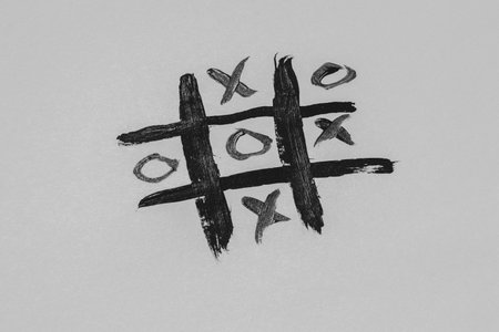 Tic-tac-toe drawn with a brush on a white background, children's board gameの写真素材