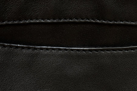 Black leather background with pocket and seams close-up, women's leather bagの写真素材