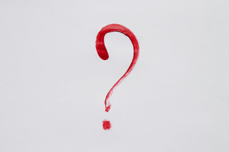 Watercolor question mark red on white background as a question symbol drawn with a brush in red...