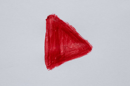 Hand drawn red play button symbol with brush on white backgroundの写真素材
