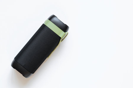 Music portable Bluetooth speaker black with green strap on white background, listen to musicの写真素材