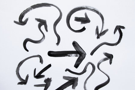 Set of black arrows painted with watercolor, different shapes, directions and curves on white background, artistic interface and design elementsの写真素材
