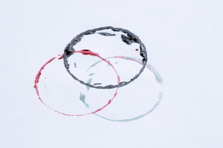 Colored watercolor circles on white background - artistic background with mug prints and ink splashes, texture for design and creativityの写真素材