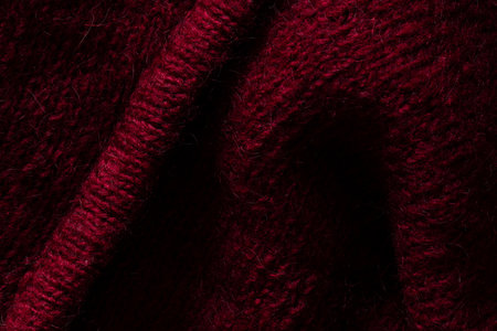 Red wool sweater close up, knitted wool texture for background close up