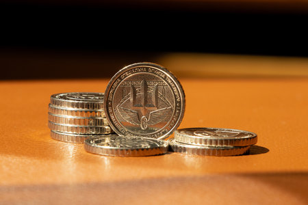 A 10 hryvnia coin with the coat of arms and the inscription State Special Transport Service placed...