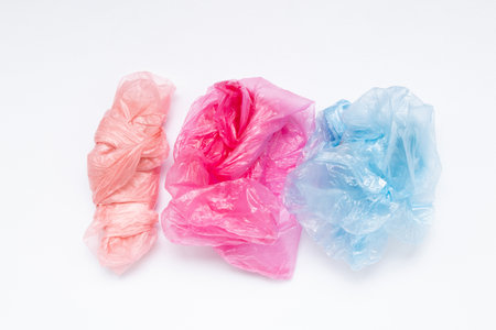 Multicolored crumpled plastic bags lying on a white background