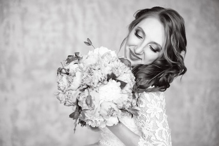Portrait of beautiful red-haired girl holding bouquet.の写真素材