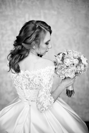 Portrait of beautiful red-haired girl holding bouquet.の写真素材