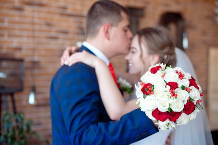 groom kisses bride in foreheadの写真素材