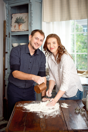 Happy couple cooking together in the kitchenの写真素材
