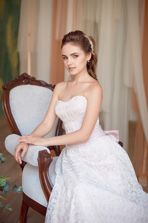 Portrait of a fashionable model sitting in a chair in Art Nouveau styleの写真素材