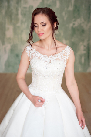 Full-length shot of a beautiful woman with makeup and elegant hairstyle on background jewelry storeの写真素材
