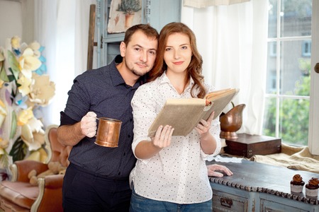 Couple reading a book of recipes to cook some dishes.の写真素材