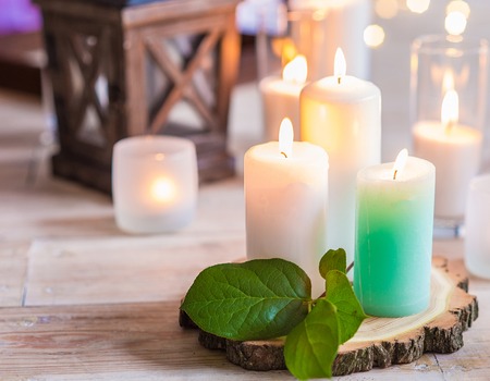 burning candles in transparent glass vasesの写真素材