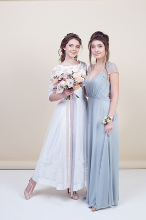 two adorable women wearing in long fashionable dressesの写真素材