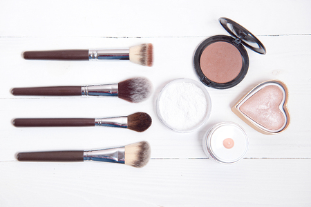 Professional makeup tools on white wooden background.の写真素材