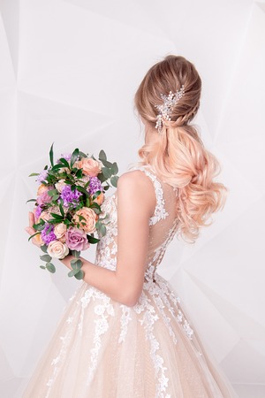 Beautiful woman holding a bouquet of flowers.の写真素材