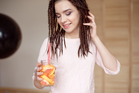 Young pretty woman holding mason jar with lemonade.の写真素材