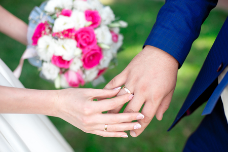 Close-up Bride and grooms hands with wedding ringsの写真素材