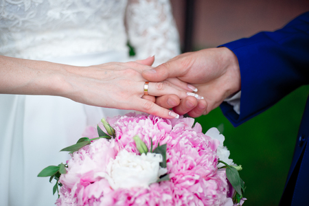 Close-up Bride and grooms hands with wedding ringsの写真素材
