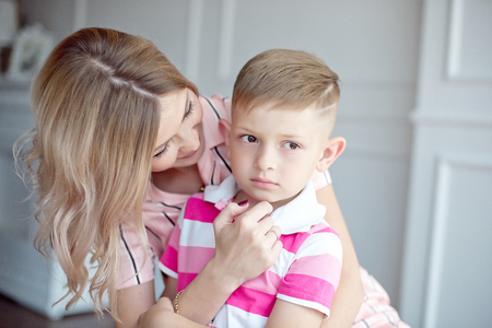 mother hugs her little boy while he upsetの写真素材