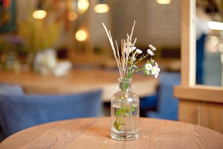 decorative bottle vase with flowers on the tableの写真素材