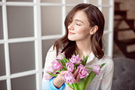 People, business, sale and floristry concept - close-up of florist woman holding bunch at flower shop.の写真素材