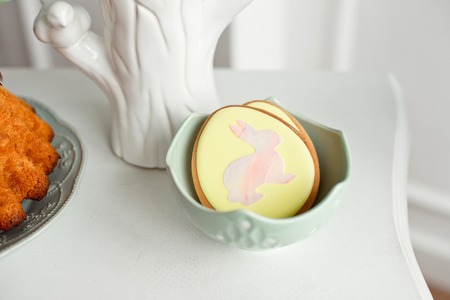 Easter spring decorative composition with homemade easter cookies in the shape of a funny rabbit,...