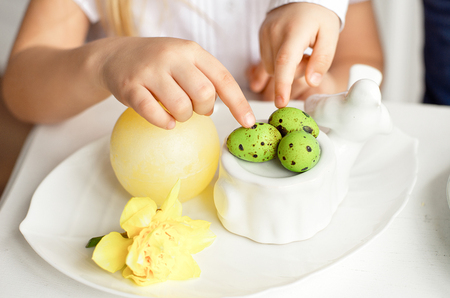 Close-up of little girl holding colorful Easter eggs.の写真素材