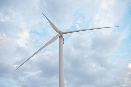 Row of wind power generators on blue sky background.