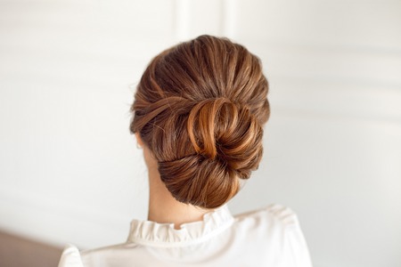 Rear view of female hairstyle medium bun with dark hair