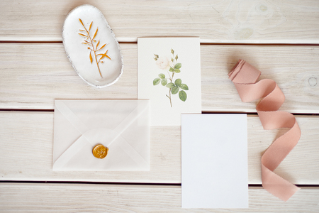 Feminine wedding desktop mock-up with blank paper card and Eucalyptus populus branch on white shabby table background. Empty space. Styled stock photo, web banner. Flat lay, top view.の写真素材